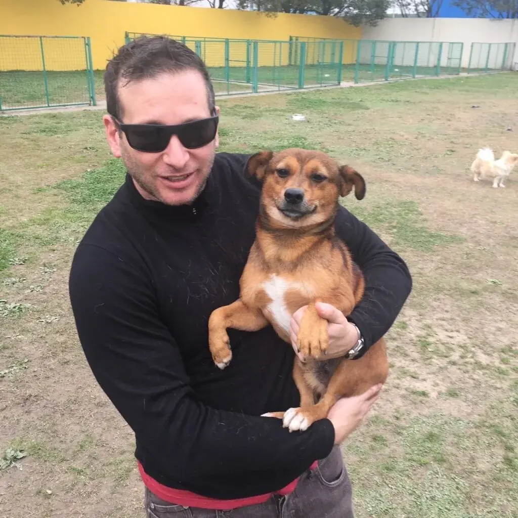 Jason Walker holding Simba, the dog he adopted on his first rescue trip