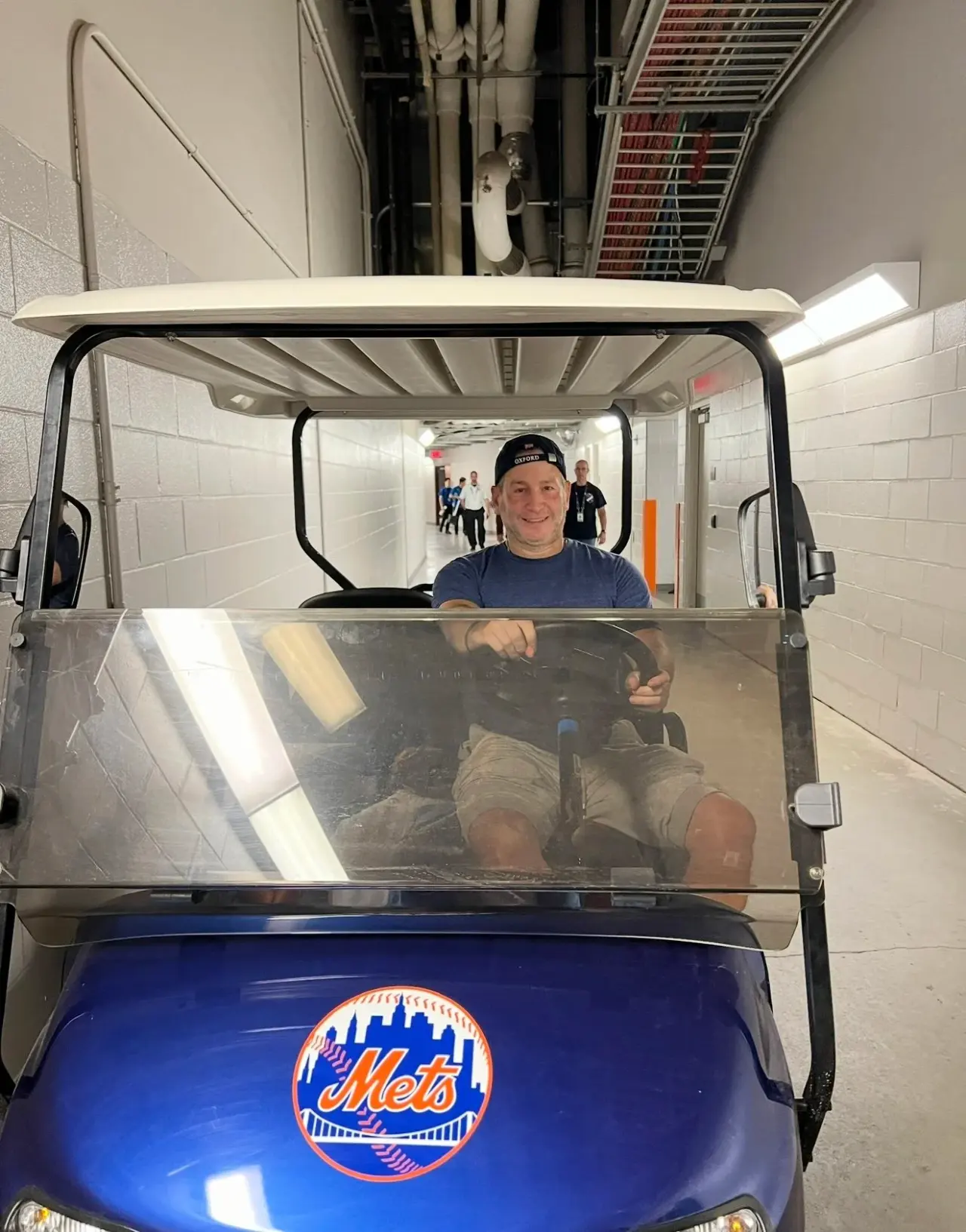 In a Mets golf cart