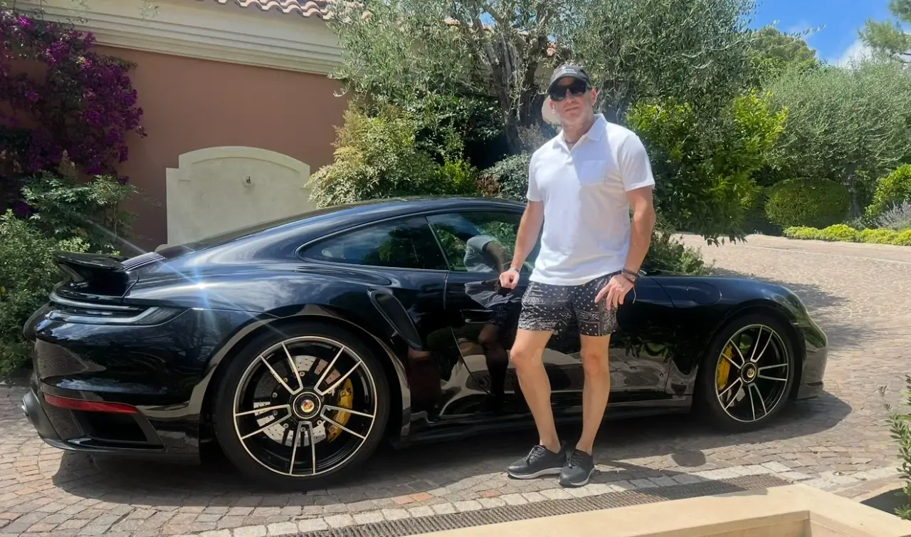 Beside a black Porsche